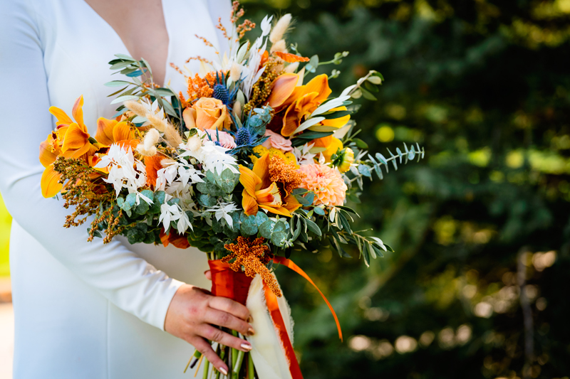 Elopement Photographer, a woman holds a large bouquet with a variety of flowers