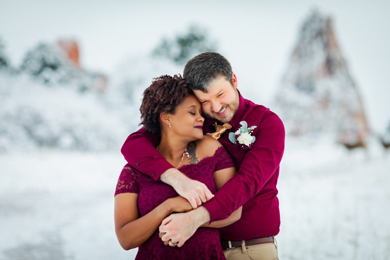 Elopement Photographer, a man and woman embrace tenderly before a snowscape behind them